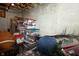 Unfinished basement storage with plastic tubs and chairs at 11727 Wedgeport Ln, Fishers, IN 46037