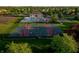 Aerial view of a basketball court, pool and playground in a green neighborhood with houses and lush trees at 11727 Wedgeport Ln, Fishers, IN 46037