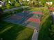 Aerial view of a community basketball court in a green neighborhood with houses and lush trees at 11727 Wedgeport Ln, Fishers, IN 46037