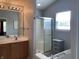 Bright bathroom with a double sink vanity, soaking tub, walk-in shower, and window with natural light at 11727 Wedgeport Ln, Fishers, IN 46037