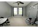Neutral bedroom features a window with white blinds, carpet, and plenty of space at 11727 Wedgeport Ln, Fishers, IN 46037