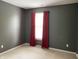 Cozy bedroom featuring gray walls, neutral carpet and bright window with red blackout curtains for restful sleep at 11727 Wedgeport Ln, Fishers, IN 46037