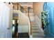 Inviting entryway with hardwood floors, staircase, and a welcoming wreath on the blue front door at 11727 Wedgeport Ln, Fishers, IN 46037