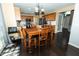 Open kitchen and dining area with wooden table, chairs, and modern appliances at 11727 Wedgeport Ln, Fishers, IN 46037