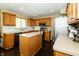 Functional kitchen featuring wooden cabinets, an island, and stainless steel appliances at 11727 Wedgeport Ln, Fishers, IN 46037