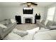 Cozy living room with a fireplace, neutral tones, and comfortable seating arrangement at 11727 Wedgeport Ln, Fishers, IN 46037