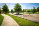Community playground featuring swings, slides and green grass at 11727 Wedgeport Ln, Fishers, IN 46037