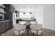 Dining area with modern chairs and sleek table, adjacent to kitchen space at 1216 N Alabama St, Indianapolis, IN 46202