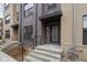 View of the townhome entrance featuring brick facade and small porch area at 1216 N Alabama St, Indianapolis, IN 46202