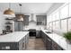 Modern kitchen with stainless steel appliances, gray cabinets, and a stylish island at 1216 N Alabama St, Indianapolis, IN 46202
