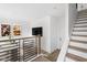 Open-concept living space with modern staircase and a comfortable seating area at 1216 N Alabama St, Indianapolis, IN 46202