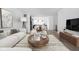 Open-concept living room with modern furniture and decorative accents, leading to the kitchen and dining area at 1216 N Alabama St, Indianapolis, IN 46202