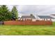 Fenced backyard offers a private retreat with a wooden deck and lush green lawn, perfect for outdoor activities and relaxation at 12328 Slate Dr, Fishers, IN 46037