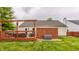 Backyard featuring a wooden deck with a BBQ and privacy fence surrounding green lawn at 12328 Slate Dr, Fishers, IN 46037