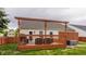 A backyard featuring a wooden deck with a privacy fence surrounding a lush green lawn at 12328 Slate Dr, Fishers, IN 46037
