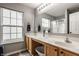 Bathroom with dual sinks, spacious countertop, large mirror, and lots of natural light at 12328 Slate Dr, Fishers, IN 46037