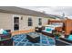 Relaxing deck features comfortable seating, a vibrant blue rug, and a luxurious hot tub for ultimate leisure at 12328 Slate Dr, Fishers, IN 46037