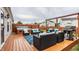 Spacious wooden deck featuring ample seating, a modern hot tub, and a built-in grill for outdoor entertaining at 12328 Slate Dr, Fishers, IN 46037