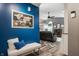 Inviting entryway with blue accent wall, stylish bench, and a glimpse into the living room at 12328 Slate Dr, Fishers, IN 46037