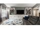 Comfortable living room with built-in shelving and a large screen TV, perfect for entertaining at 12328 Slate Dr, Fishers, IN 46037