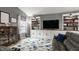 Cozy living room featuring built-in shelving, natural light, and a plush gray sofa at 12328 Slate Dr, Fishers, IN 46037