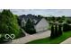Aerial view of a home with a three car garage, large driveway, well maintained yard, and brick fence at 13868 Broad Mdw, Carmel, IN 46032