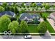 Aerial view of a stunning home with manicured lawn, mature trees, and a spacious driveway at 13868 Broad Mdw, Carmel, IN 46032