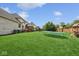 Huge backyard with green grass, trampoline, playhouse and a brick fence at 13868 Broad Mdw, Carmel, IN 46032