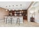 Finished basement featuring wet bar with stools, cabinets, pendant lighting, and a wine fridge at 13868 Broad Mdw, Carmel, IN 46032