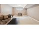 Finished basement with neutral walls and carpet, a window, sofa, and a black coffee table at 13868 Broad Mdw, Carmel, IN 46032