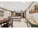 Finished basement features open space with a ping pong table, TV, sofa, and neutral walls and carpet at 13868 Broad Mdw, Carmel, IN 46032