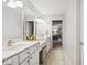 Bathroom featuring double sinks, vanity with marble countertop and tile flooring at 13868 Broad Mdw, Carmel, IN 46032