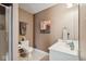 Neutral bathroom featuring a glass enclosed shower, single sink vanity and decorative wall art at 13868 Broad Mdw, Carmel, IN 46032