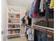Walk-in closet with built-in shelving and storage, including an organized display of clothing and personal items at 13868 Broad Mdw, Carmel, IN 46032