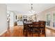 Elegant dining room with hardwood floors, modern lighting, and open access to the living space at 13868 Broad Mdw, Carmel, IN 46032