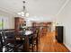 Open-concept kitchen and dining area with wood floors, custom cabinets, and stainless steel appliances at 13868 Broad Mdw, Carmel, IN 46032