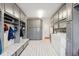 Spacious laundry room featuring gray cabinetry and storage with a utility sink and a washer and dryer at 13868 Broad Mdw, Carmel, IN 46032