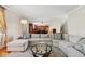 Comfortable living room featuring a large sectional sofa and an open view to the kitchen at 13868 Broad Mdw, Carmel, IN 46032