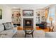 Cozy living room with a fireplace, built-in shelving, and comfortable seating at 13868 Broad Mdw, Carmel, IN 46032