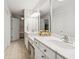 Bright main bathroom with double sinks, vanity, and a marble countertop at 13868 Broad Mdw, Carmel, IN 46032
