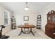 Bright office with a large desk, decorative shelves, and neutral carpet at 13868 Broad Mdw, Carmel, IN 46032