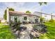 Manicured backyard features a patio with outdoor furniture, lush grass, and a flowerbed at 14291 Holly Berry Cir, Fishers, IN 46038
