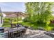 Backyard features a patio with outdoor furniture, lush grass, and a shade tree, perfect for relaxing at 14291 Holly Berry Cir, Fishers, IN 46038