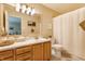 Bathroom features a wood vanity, neutral decor, and a bathtub with shower, offering a modern design at 14291 Holly Berry Cir, Fishers, IN 46038