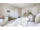 Well-lit bedroom features a queen bed, neutral decor, and relaxing chair, offering a calm design at 14291 Holly Berry Cir, Fishers, IN 46038