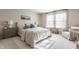 Bright bedroom features a queen bed, neutral decor, and abundant natural light from large windows at 14291 Holly Berry Cir, Fishers, IN 46038