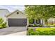 Home featuring a garage and inviting front yard with dark shutters and chairs at 14291 Holly Berry Cir, Fishers, IN 46038