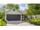 Exterior view of home featuring a garage, inviting front yard, and manicured landscaping at 14291 Holly Berry Cir, Fishers, IN 46038