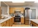 Well-lit kitchen featuring stainless steel appliances, light wood cabinetry, and ample counter space at 14291 Holly Berry Cir, Fishers, IN 46038