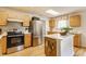 Efficient kitchen design with modern appliances, wooden cabinets, and an island for additional workspace at 14291 Holly Berry Cir, Fishers, IN 46038